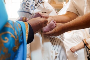 Orthodox Christian Baptism Ceremony with Priest Anointing Infant's Feet, White Robes, Spiritual...