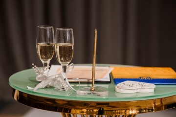 Elegant Wedding Toast Setup: Champagne Glasses, Gold Decor, Teal Table, and Romantic Accessories...