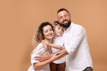 Portrait of happy family on beige background