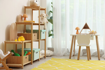 Stylish playroom with toys and furniture. Interior design