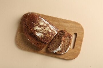 Pieces of fresh rye bread on beige background, top view