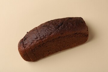 Fresh rye bread on beige background, above view