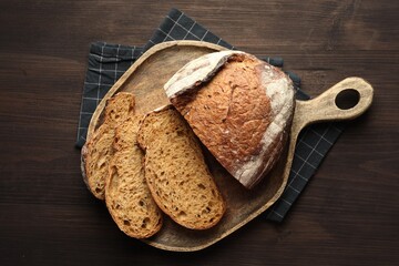 Pieces of fresh bread on wooden table, top view