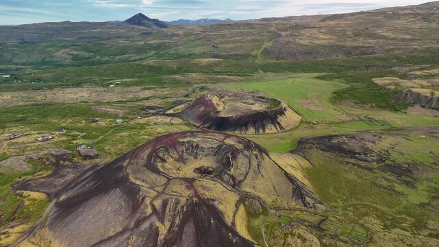 Discover the breathtaking beauty of Grabrok crater in Iceland. This natural wonder showcases vibrant volcanic colors and lush greenery, inviting adventurers to explore its stunning surroundings.