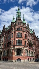 Hamburg, Germany - April 25, 2025: Speicherstadt warehouses in Hamburg. Fleetschloss. View from Poggenmuhlen bridge to Water Castle at sunset. Warehouses along the canal in Speicherstadt, Hamburg