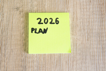 bright yellow sticky note with goal (plan) 2026 written on it, motivational concept for future...