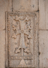 Stone wall with carved pattern in ancient temple, Geghard, Armenia
