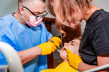 Dentistry. Professional dentist injects a local anesthetic into the patient with a syringe. Tooth...