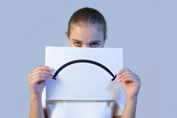 young woman holding a sad signage