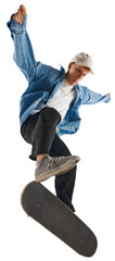 Skater balancing mid-flip over board with determined face and flying arms in denim, on transparent...