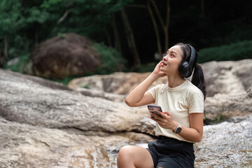 Listening to Music in Nature. Young woman enjoying tunes outdoors.