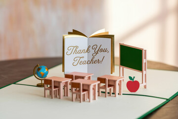 Thank you teacher card with miniature classroom setup and educational elements