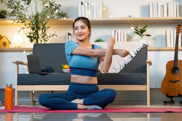 Yoga and Stretching. Woman performing arm stretch on yoga mat.