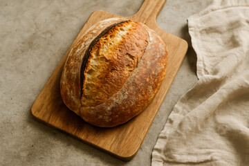 Freshly baked artisanal bread resting on a wooden board