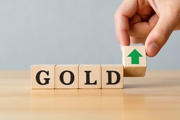 Rising Gold Investment is symbolized by wooden blocks, where an upward-pointing arrow signifies portfolio growth and financial aspiration for a prosperous future.