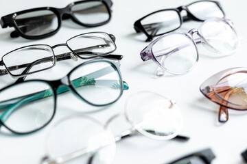 Many different styles of eyeglasses with lenses on white. Eye care and protection concept