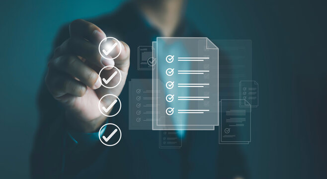 Businessman checklist concept as clipboard document checklist form on the virtual screen Use your hands or a pen to check the correct control gaps and check the quality standards of the work.	