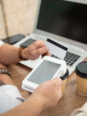Businessman using card reader for payment processing