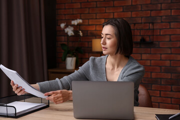 Woman working at desk in home office