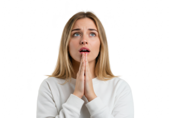 A young woman with hands clasped in prayer looks upwards with a hopeful expression isolated on transparent background