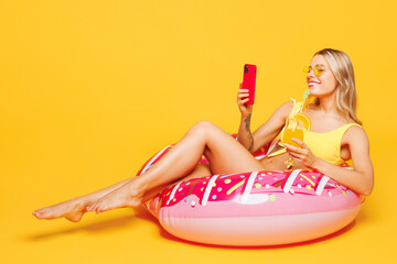 Full body young beautiful sexy woman wear bikini swimsuit rest near hotel pool lies on rubber ring...