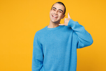 Young smiling happy middle eastern man wearing blue sweatshirt casual clothes doing phone gesture...