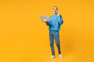 Young IT middle eastern man he wear blue sweatshirt casual clothes hold use work on laptop pc...