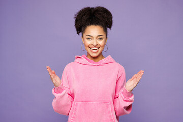 Young shocked surprised excited overjoyed woman of African American ethnicity wear pink hoodie...