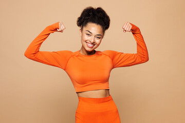Young strong fitness trainer instructor sporty woman sportswoman wear orange clothes spend time...