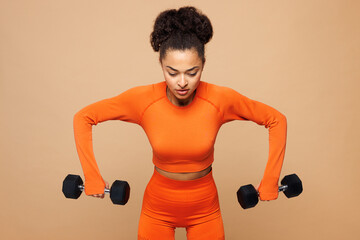 Young strong fitness trainer instructor sporty woman sportswoman wear orange clothes spend time in...