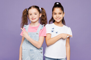 Little smiling two friends kids children girls 9-10 years old wear casual clothes together point...