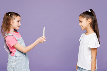 Little smiling cheerful two friends kids children girls 9-10 years old wear casual clothes together...