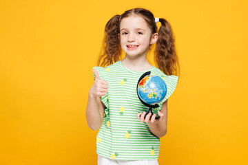 Little smiling cheery cute kid child girl 8-9 years old wears green t-shirt hold in hand Earth map...