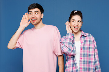Young curious nosy couple two friends family man woman they wearing pink casual clothes together...