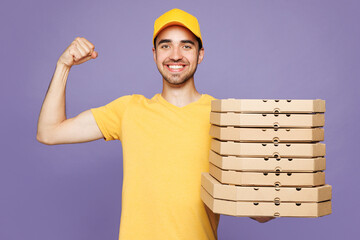 Young strong delivery guy employee man wears yellow cap t-shirt uniform workwear work as dealer...