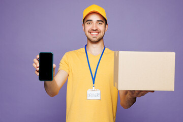 Young delivery guy employee man wearing yellow cap t-shirt uniform workwear work dealer courier...