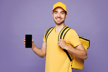 Young delivery guy employee man he wear cap t-shirt uniform workwear work as dealer courier hold...