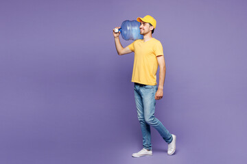 Young happy delivery guy employee man wear yellow cap t-shirt uniform workwear work as dealer...