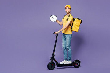 Full body young delivery guy employee man he wear yellow cap t-shirt uniform workwear thermal bag...
