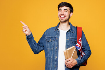 Young clever English boy student he wear denim casual clothes backpack bag hold books British flag...