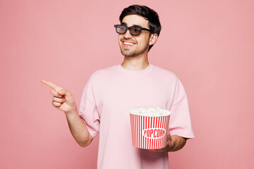 Young smiling woman wears t-shirt casual clothes 3d glasses watch movie film hold bucket of popcorn...
