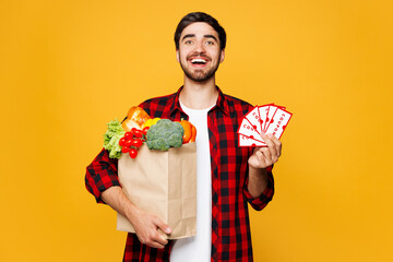 Young man he wearing casual clothes hold bag for takeaway mock up with food products gift coupon...