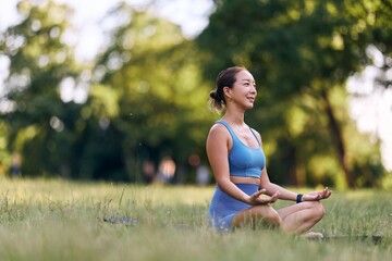 Woman Meditating Outdoors in Peaceful Green Park Atmosphere