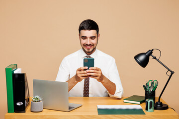 Young successful employee business man wears white shirt tie sit work at office desk with pc laptop...