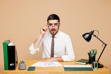 Young successful employee business man wears white shirt tie touch lower glasses sit work at office...