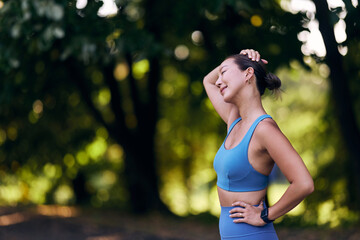 Woman Relaxing Outdoors After Exercise in Bright Light Surrounded by Nature