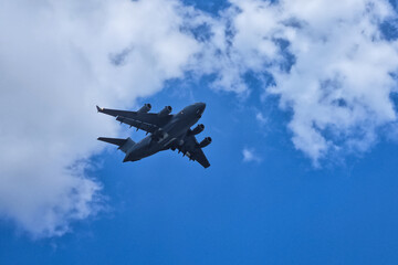 A plane gracefully soaring through the azure sky.