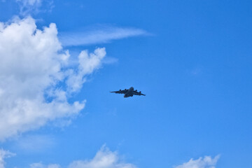 A plane soaring high in the sky.