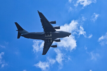 Large airplane soaring through a clear blue sky.