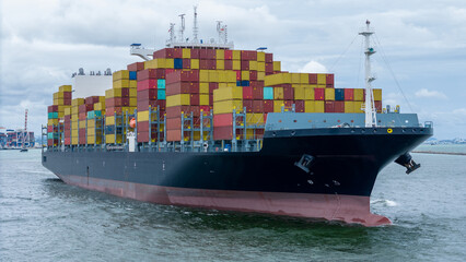 front of cargo ship carrying container and running for export goods from cargo yard port to custom...